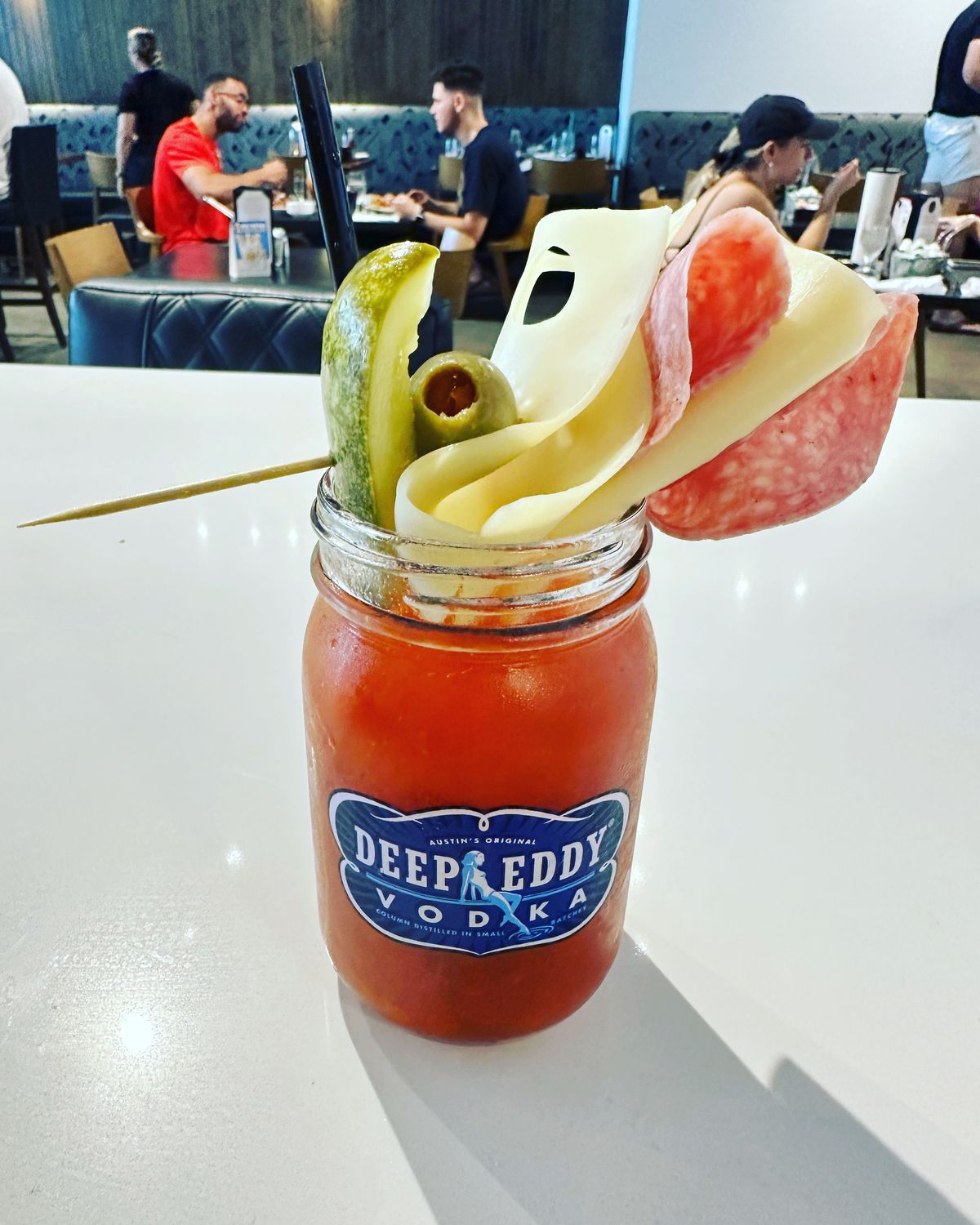 Bloody mary loaded with cheese, meat and pickled garnishes