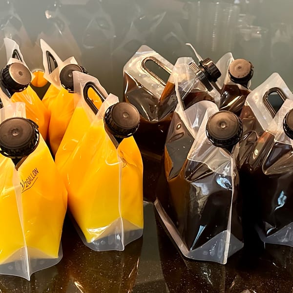 Half-gallon pouches of orange juice and iced coffee from New York Bagels 'N Bialys.